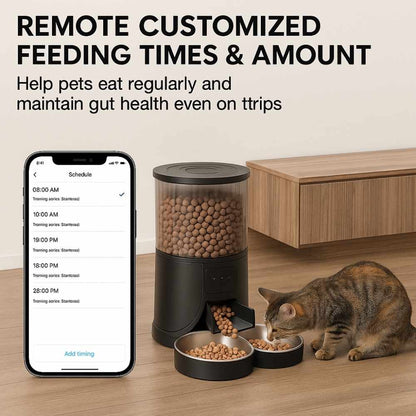 Automatic pet feeder with dual bowls and smartphone app showing custom feeding schedule, cat eating from bowl on wooden floor